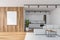 White and wooden kitchen with sofa and poster