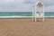 White wooden lifeguards hut on a sandy beach