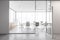 White wooden office meeting room with table and armchairs behind glass door