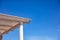 White wooden pergola details, clear blue sky background, copy space, closeup view