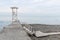 White wooden rescue tower on the breakwater. Low staircase lead