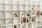 White wooden shelves with old books. Wooden bookcase.