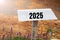 White wooden signpost with the year 2025