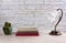 White Wooden Table with Books a Lamp and a Cactus