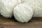 White Wool Rolls On Wood Background