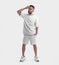White wrinkled suit mockup, oversized t-shirt, shorts on a guy with a beard, in sneakers, straightening his hair, isolated on