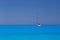 White yacht anchored in fantastic Myrtos Beach turquoise and blue bay. Summer scenery of famous and extremely popular