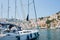 White yacht arriving to colorful Symi harbour on a sunny day, Greece