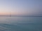 White yacht on clear turquoise waters of Caribbean Sea landscape in Cancun city in Mexico at evening