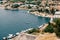 White yachts stand on the pier near the town of Sibenik against the backdrop of old houses. View from above