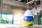 white, yellow and blue hard safety helmet for safety accident stack on floor at workplace in construction site building, leader