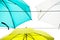 White, yellow and green umbrellas hang together