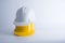 White and yellow safety helmet on white background. Hard hat and thick gloves on white isolated background. Safety equipment