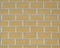 White-yellow wall with a large imitation brick