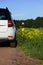 White youth car parked by the side of the road during a travel picnic. Outdoor weekends, local travel