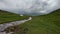 White yurt among green fields and rivers