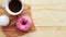 White zefir, coffee cup and pink donut on wooden table, top view.