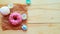 White zefir and pink donut on wooden table, top view.