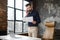 Whitecollar worker on laptop gesturing while holding paper