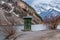 Whitemanâ€™s Pond outhouse perched on the edge of the pond in Kananaskis, Alberta