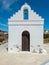 Whitewashed chapel and belfry at Kimolos island Cyclades Greece. Vertical