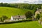 Whitewashed cottage in rural setting.