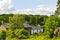 Whitewashed cottage in woodland setting.