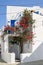 Whitewashed cycladic house with flowers