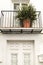 Whitewashed facade with beautiful fern plant in the balcony