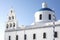 Whitewashed houses and blue dome church by the Aegean sea, Santoriniin Oia, Santorini, Greece. Famous blue domes in Oia village,