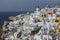 Whitewashed Houses and Windmill on Cliffs with Sea View in Oia,
