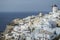 Whitewashed Houses and Windmill on Cliffs with Sea View in Oia,