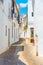 Whitewashed street of the old town of Arcos de la Frontera, one of pueblos blancos, in Spain