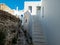 Whitewashed traditional buildings and stairs empty alley sunny day, Kythnos island, Cyclades Greece