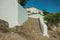 Whitewashed wall and cobblestone pathway with large stairs