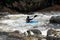 Whitewater canoeing on rough water in rugged rocky river