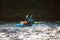 Whitewater kayaker paddling on river