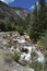 Whitewater Mountain Stream with Forest and Mountains