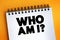 Who Am I Question text quote on notepad, concept background