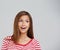 Who knew. Studio shot of an attractive young woman looking surprised on a grey background.