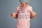 Who said boys cant wear pink. Studio shot of a boy wearing a t shirt with Im a boy printed on it against a gray