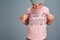 Who said boys cant wear pink. Studio shot of a boy wearing a t shirt with Im a boy printed on it against a grey