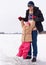 Whoa Youll find your balance soon. Older brother teaching his daughter how to skate on a frozen natural lake.