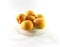 Whole apricots on a plate. Isolated photo. Yellow ripe round apricots