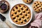 Whole baked mixed berry crust pie or tart with lattice, and mini tarts. Homemade