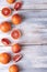 Whole blood oranges and slices on a white wooden background, top view