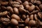 Whole brown coffee grains close-up. The aroma of coffee