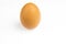 Whole brown hens egg on a white background