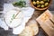 Whole Camembert cheese with thyme, olives and baguette