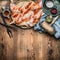Whole chicken flattened out with condiment and kitchen tools on wooden rustic background, cooking preparation , top view. Chicken